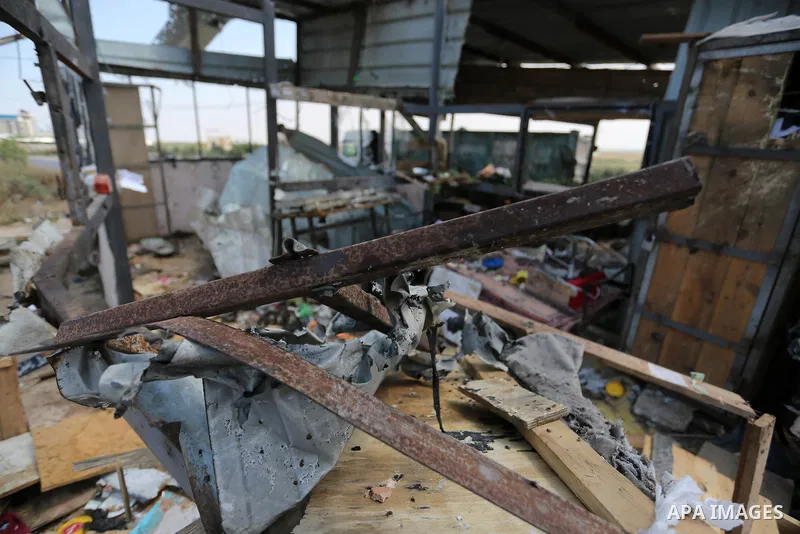 Palestinians inspect the site targeted by Israeli tank fire on the outskirts of Gaza City, near the border with Israel, on April 11, 2018. Israeli tanks shelled sites in eastern Gaza City on Wednesday morning, in what th...