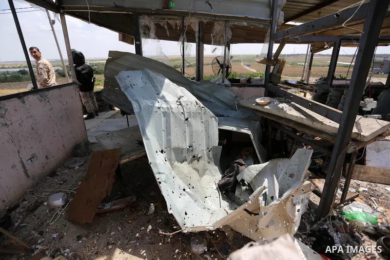 Palestinians inspect the site targeted by Israeli tank fire on the outskirts of Gaza City, near the border with Israel, on April 11, 2018. Israeli tanks shelled sites in eastern Gaza City on Wednesday morning, in what th...