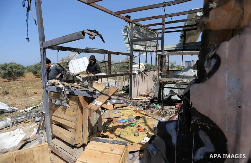 Palestinians inspect the site targeted by Israeli tank fire on the outskirts of Gaza City, near the border with Israel, on April 11, 2018. Israeli tanks shelled sites in eastern Gaza City on Wednesday morning, in what th...