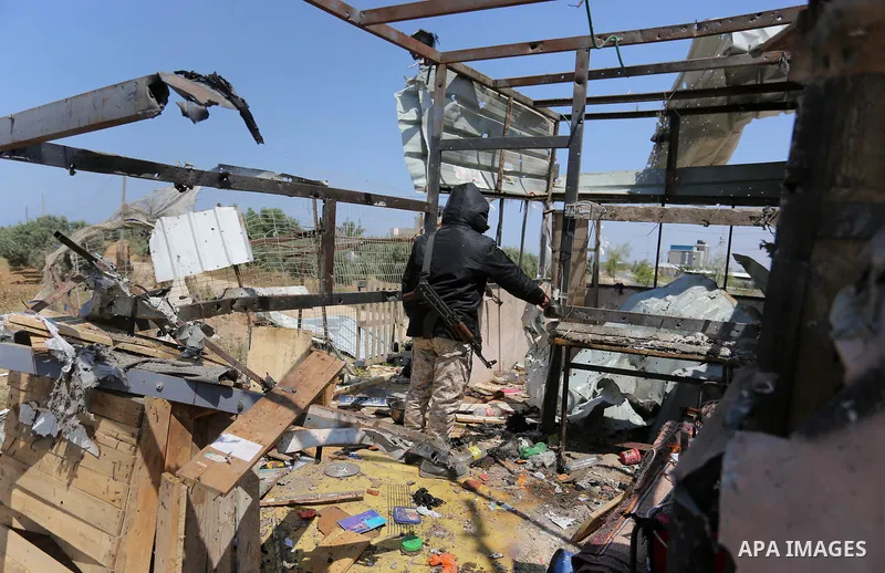 Palestinians inspect the site targeted by Israeli tank fire on the outskirts of Gaza City, near the border with Israel, on April 11, 2018. Israeli tanks shelled sites in eastern Gaza City on Wednesday morning, in what th...