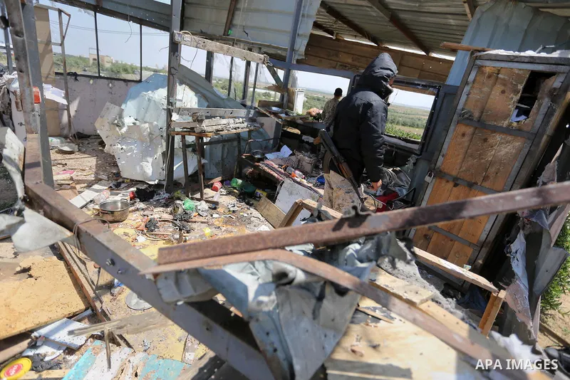 Palestinians inspect the site targeted by Israeli tank fire on the outskirts of Gaza City, near the border with Israel, on April 11, 2018. Israeli tanks shelled sites in eastern Gaza City on Wednesday morning, in what th...