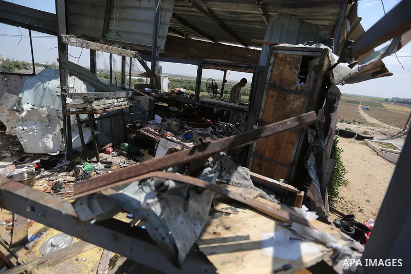Palestinians inspect the site targeted by Israeli tank fire on the outskirts of Gaza City, near the border with Israel, on April 11, 2018. Israeli tanks shelled sites in eastern Gaza City on Wednesday morning, in what th...