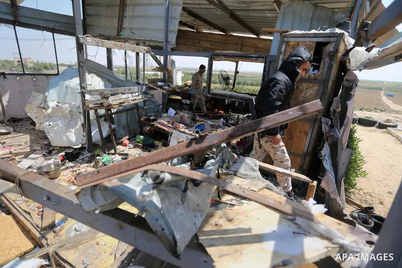 Palestinians inspect the site targeted by Israeli tank fire on the outskirts of Gaza City, near the border with Israel, on April 11, 2018. Israeli tanks shelled sites in eastern Gaza City on Wednesday morning, in what th...