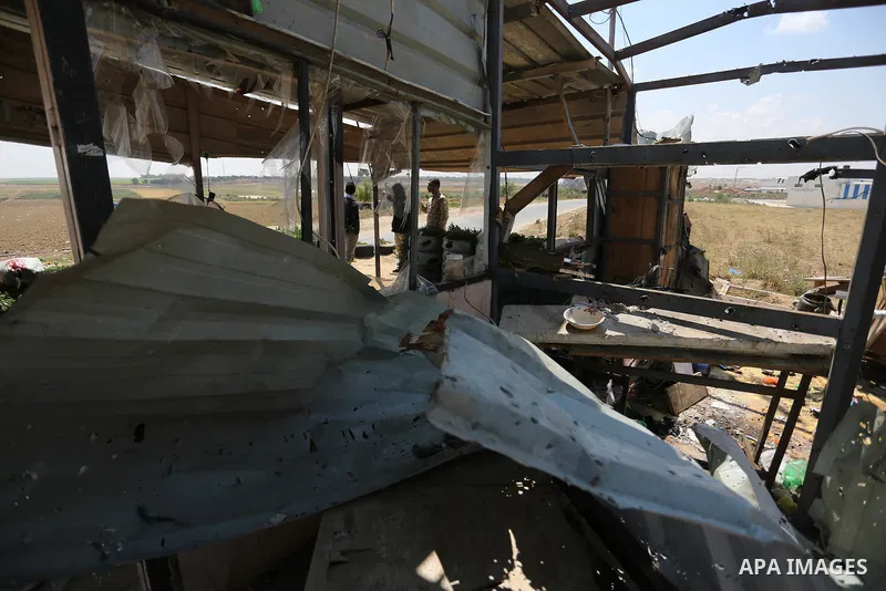 Palestinians inspect the site targeted by Israeli tank fire on the outskirts of Gaza City, near the border with Israel, on April 11, 2018. Israeli tanks shelled sites in eastern Gaza City on Wednesday morning, in what th...
