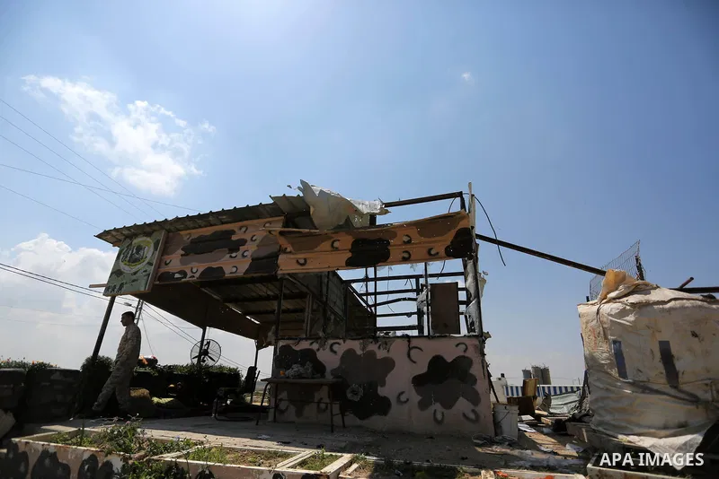 Palestinians inspect the site targeted by Israeli tank fire on the outskirts of Gaza City, near the border with Israel, on April 11, 2018. Israeli tanks shelled sites in eastern Gaza City on Wednesday morning, in what th...