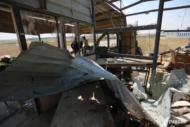 Members of Hamas movement's security apparatus inspect the site targeted by Israeli tank fire on the outskirts of Gaza City, near the border with Israel, on April 11, 2018. Israeli tanks shelled sites in eastern Gaza Cit...