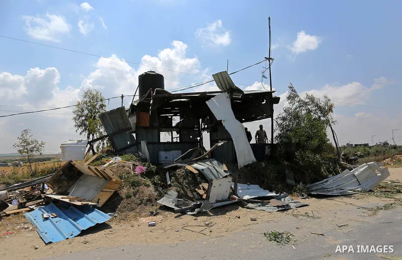 Members of Hamas movement's security apparatus inspect the site targeted by Israeli tank fire on the outskirts of Gaza City, near the border with Israel, on April 11, 2018. Israeli tanks shelled sites in eastern Gaza Cit...