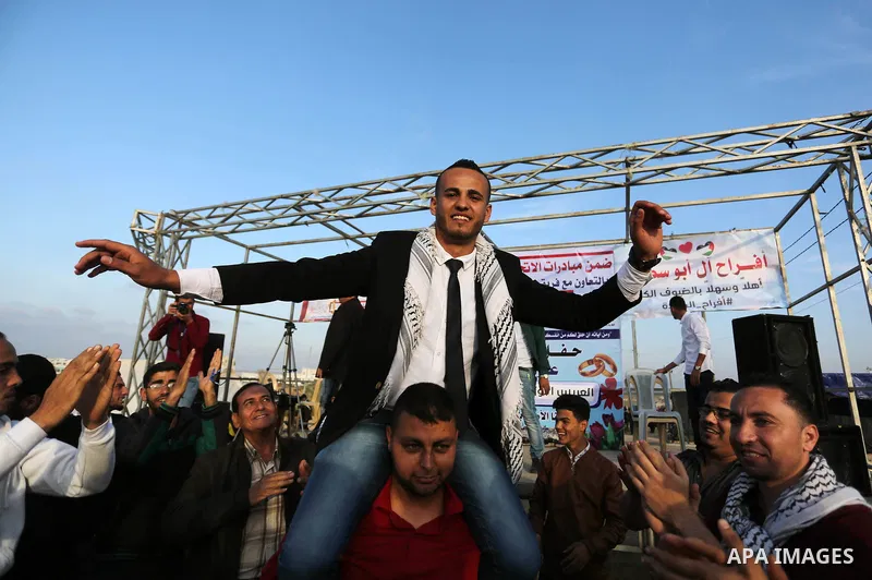 Palestinian groom Ramadan Abu Sukkar celebrates during his wedding near tents during a tent city protest demanding the right to return to their homeland, at the Israel-Gaza border in the east of Gaza city on April 11, 20...