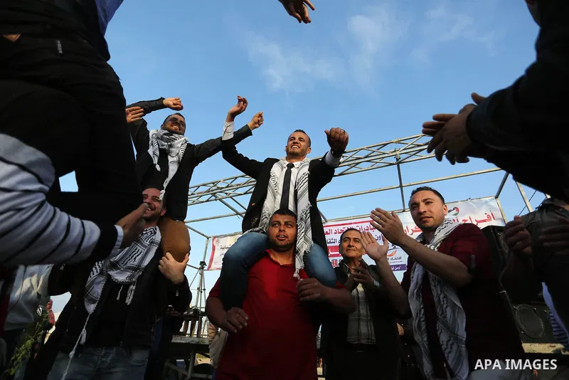Palestinian groom Ramadan Abu Sukkar celebrates during his wedding near tents during a tent city protest demanding the right to return to their homeland, at the Israel-Gaza border in the east of Gaza city on April 11, 20...