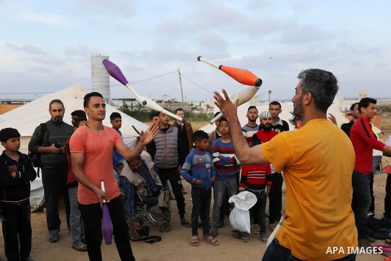 Palestinians show their skills near tents during a tent city protest demanding the right to return to their homeland, at the Israel-Gaza border in the east of Gaza city on April 11, 2018. Photo by Ashraf Amra