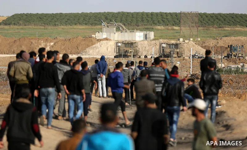 Palestinian protesters demontrate during clashes with Israeli security forces during a tent city protest demanding the right to return to their homeland, at the Israel-Gaza border in the east of Gaza city on April 11, 20...