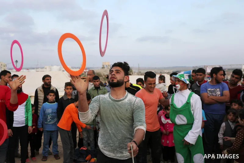 Palestinians show their skills near tents during a tent city protest demanding the right to return to their homeland, at the Israel-Gaza border in the east of Gaza city on April 11, 2018. Photo by Ashraf Amra