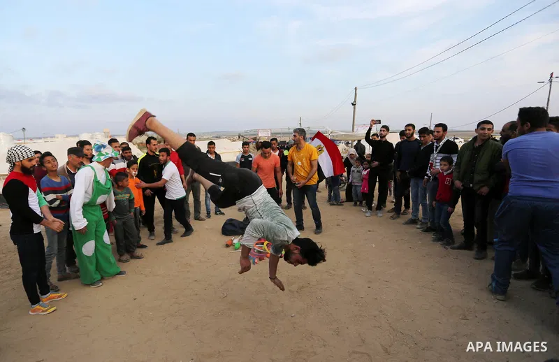 Palestinians show their skills near tents during a tent city protest demanding the right to return to their homeland, at the Israel-Gaza border in the east of Gaza city on April 11, 2018. Photo by Ashraf Amra