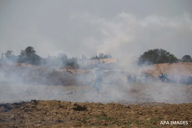 Palestinian protesters clash with Israeli security forces during a tent city protest where Palestinians demand the right to return to their homeland, at the Israel-Gaza border, in the cetner of Gaza strip on April 13, 20...