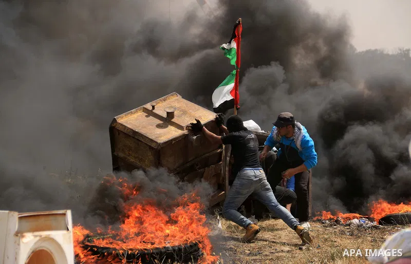 Palestinian protesters clash with Israeli security forces during a tent city protest where Palestinians demand the right to return to their homeland, at the Israel-Gaza border, in the cetner of Gaza strip on April 13, 20...