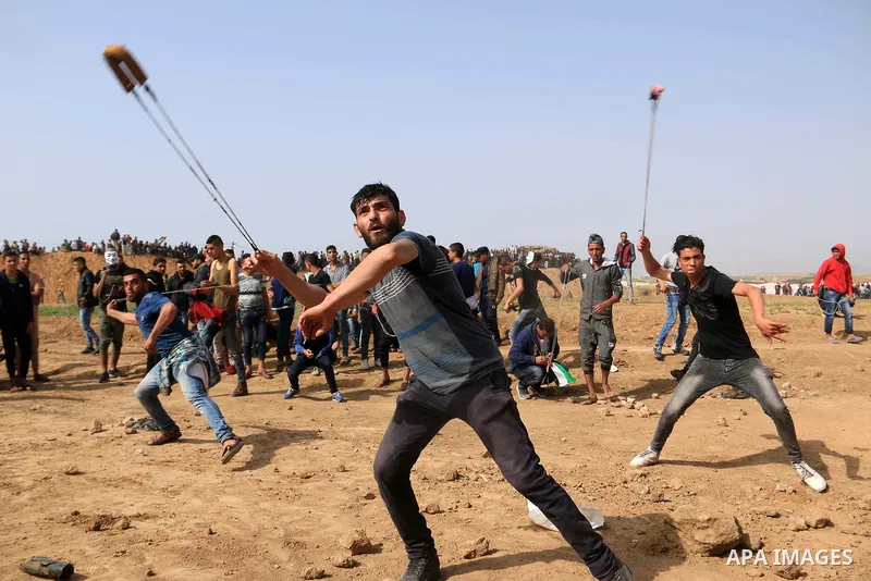 Palestinian protesters clash with Israeli security forces during a tent city protest where Palestinians demand the right to return to their homeland, at the Israel-Gaza border, in the cetner of Gaza strip on April 13, 20...