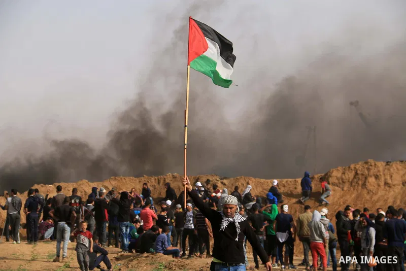 Palestinian protesters clash with Israeli security forces during a tent city protest where Palestinians demand the right to return to their homeland, at the Israel-Gaza border, in the cetner of Gaza strip on April 13, 20...
