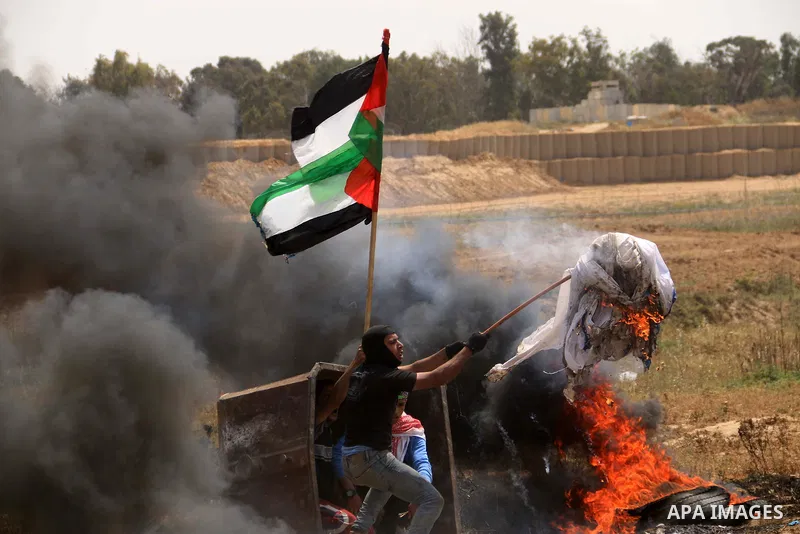 Palestinian protesters clash with Israeli security forces during a tent city protest where Palestinians demand the right to return to their homeland, at the Israel-Gaza border, in the cetner of Gaza strip on April 13, 20...