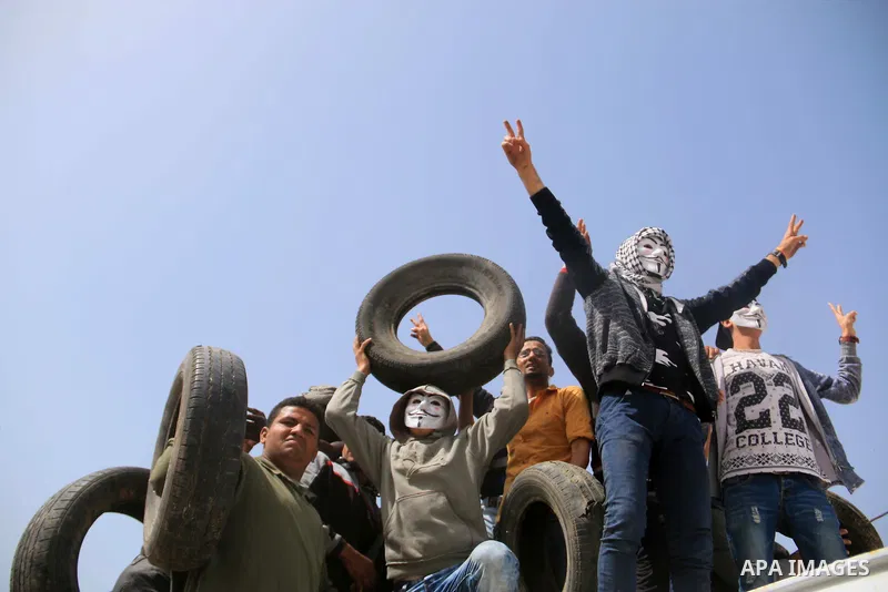 Palestinian protesters clash with Israeli security forces during a tent city protest where Palestinians demand the right to return to their homeland, at the Israel-Gaza border, in the cetner of Gaza strip on April 13, 20...