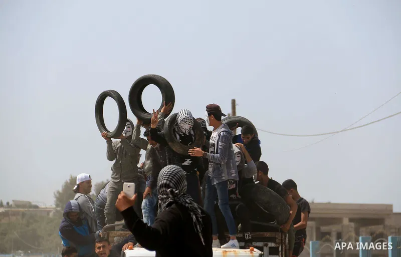 Palestinian protesters clash with Israeli security forces during a tent city protest where Palestinians demand the right to return to their homeland, at the Israel-Gaza border, in the cetner of Gaza strip on April 13, 20...