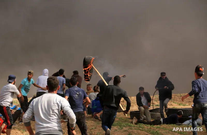 Palestinian protesters clash with Israeli security forces during a tent city protest where Palestinians demand the right to return to their homeland, at the Israel-Gaza border, in the cetner of Gaza strip on April 13, 20...