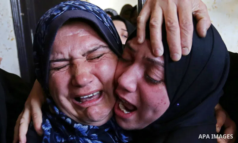 Female relatives of Islam Herzallah, 28, who was killed during clashes with Israeli security forces at the Israel-Gaza border, mourn during his funeral in Gaza City on April 14, 2018. Photo by Ashraf Amra