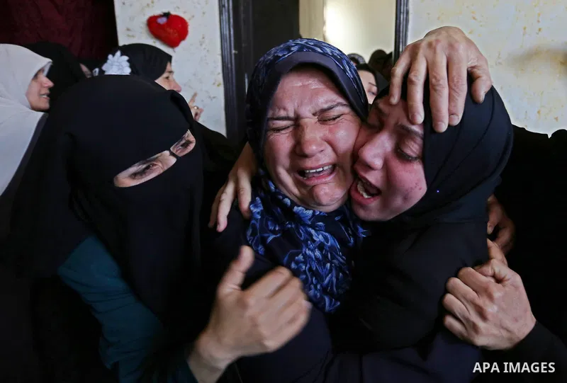 Female relatives of Islam Herzallah, 28, who was killed during clashes with Israeli security forces at the Israel-Gaza border, mourn during his funeral in Gaza City on April 14, 2018. Photo by Ashraf Amra