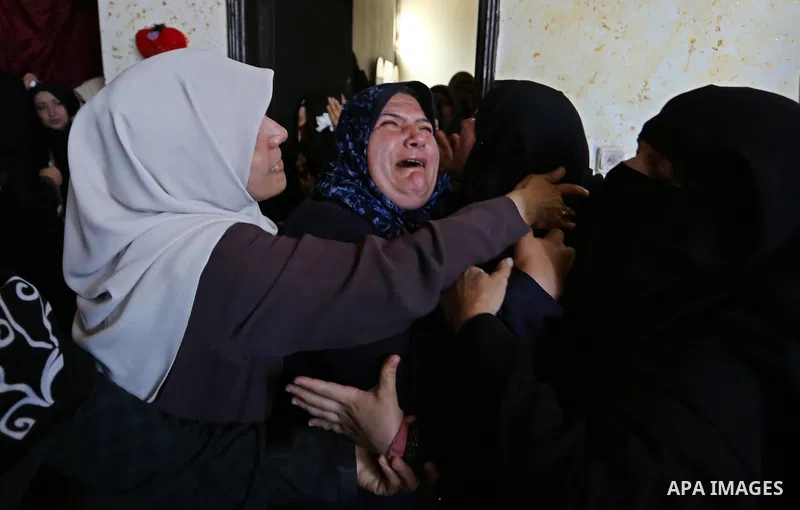 Female relatives of Islam Herzallah, 28, who was killed during clashes with Israeli security forces at the Israel-Gaza border, mourn during his funeral in Gaza City on April 14, 2018. Photo by Ashraf Amra