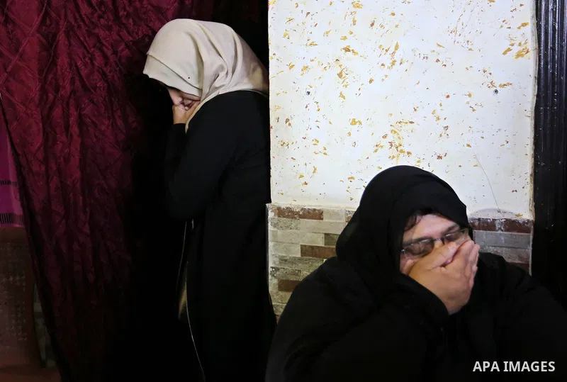 Female relatives of Islam Herzallah, 28, who was killed during clashes with Israeli security forces at the Israel-Gaza border, mourn during his funeral in Gaza City on April 14, 2018. Photo by Ashraf Amra