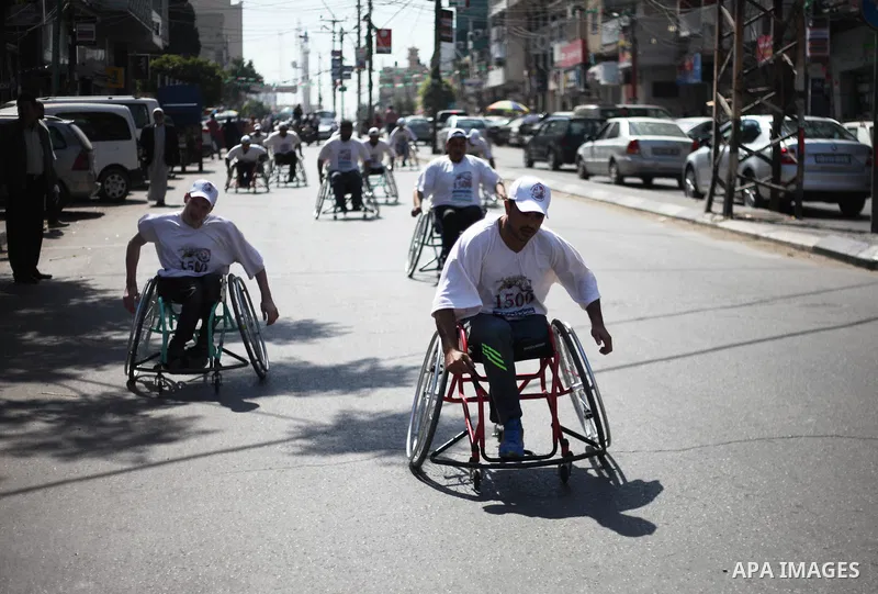 Disabled Palestinians take part in a marathon to shwo solidarity with Palestinian prisoners held in Israli jails, in Gaza city on April 15, 2018. Photo by Mahmoud Ajour