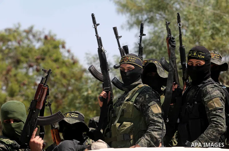Palestinian militants from the Al-Quds Brigades, the armed wing of the Islamic Jihad movement attend the funeral of their comrades who were killed in an explosion in the previous day, in Rafah in the southern Gaza Strip...
