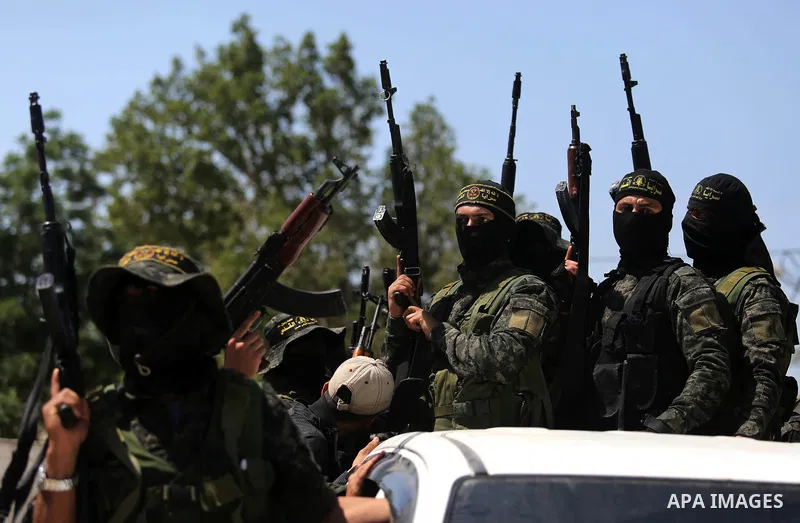 Palestinian militants from the Al-Quds Brigades, the armed wing of the Islamic Jihad movement attend the funeral of their comrades who were killed in an explosion in the previous day, in Rafah in the southern Gaza Strip...
