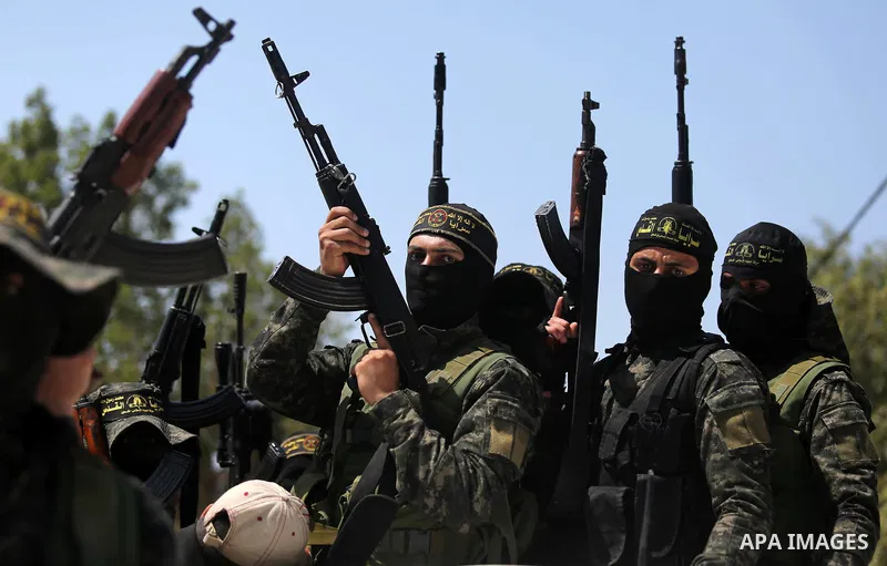 Palestinian militants from the Al-Quds Brigades, the armed wing of the Islamic Jihad movement attend the funeral of their comrades who were killed in an explosion in the previous day, in Rafah in the southern Gaza Strip...