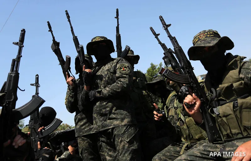 Palestinian militants from the Al-Quds Brigades, the armed wing of the Islamic Jihad movement attend the funeral of their comrades who were killed in an explosion in the previous day, in Rafah in the southern Gaza Strip...