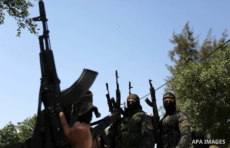 Palestinian militants from the Al-Quds Brigades, the armed wing of the Islamic Jihad movement attend the funeral of their comrades who were killed in an explosion in the previous day, in Rafah in the southern Gaza Strip...