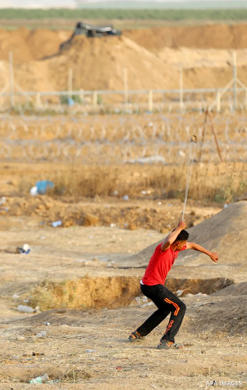 Palestinians gather during clashes with Israeli security forces in a tent city protest along Israel border with Gaza, demanding to return to their homeland, east of Gaza City, April 18, 2018. Photo by Yasser Qudih