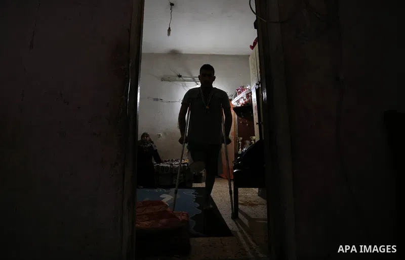 Palestinian cyclist Alaa Al-Daly, 21, who lost his leg by a bullet fired by Israeli troops along the Gaza border during a protest, walks using crutches at his home in Rafah in the southern Gaza Strip on April 19, 2018. D...