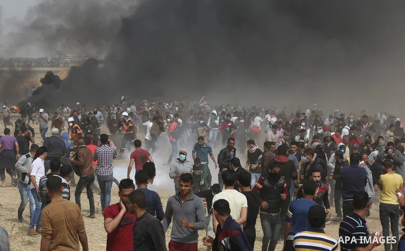 Palestinian protesters burn tires during clashes with Israeli security forces at tents protest at the Israel-Gaza border where Palestinians demand the right to return to their homeland, in Khan Younis in the southern Gaz...