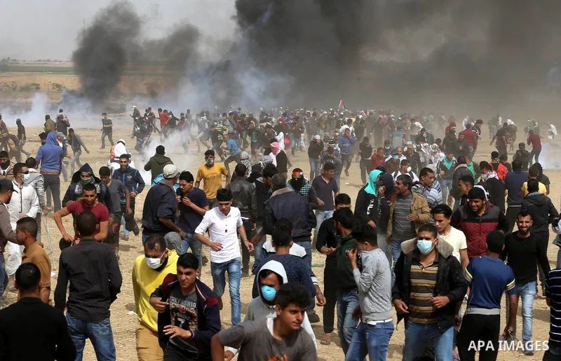 Palestinian protesters burn tires during clashes with Israeli security forces at tents protest at the Israel-Gaza border where Palestinians demand the right to return to their homeland, in Khan Younis in the southern Gaz...