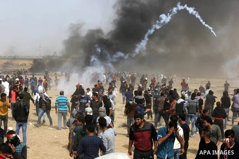 Palestinian protesters burn tires during clashes with Israeli security forces at tents protest at the Israel-Gaza border where Palestinians demand the right to return to their homeland, in Khan Younis in the southern Gaz...