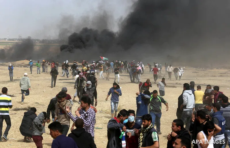 Palestinian protesters burn tires during clashes with Israeli security forces at tents protest at the Israel-Gaza border where Palestinians demand the right to return to their homeland, in Khan Younis in the southern Gaz...