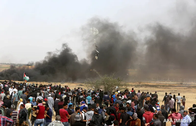 Palestinian protesters burn tires during clashes with Israeli security forces at tents protest at the Israel-Gaza border where Palestinians demand the right to return to their homeland, in Khan Younis in the southern Gaz...