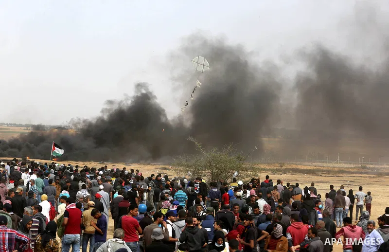 Palestinian protesters burn tires during clashes with Israeli security forces at tents protest at the Israel-Gaza border where Palestinians demand the right to return to their homeland, in Khan Younis in the southern Gaz...