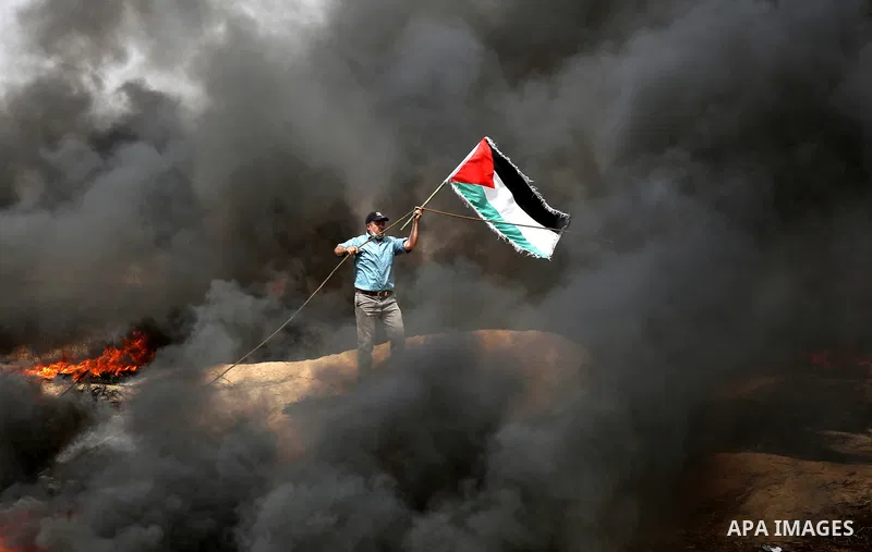 Palestinian protesters burn tires during clashes with Israeli security forces at tents protest at the Israel-Gaza border where Palestinians demand the right to return to their homeland, in Khan Younis in the southern Gaz...