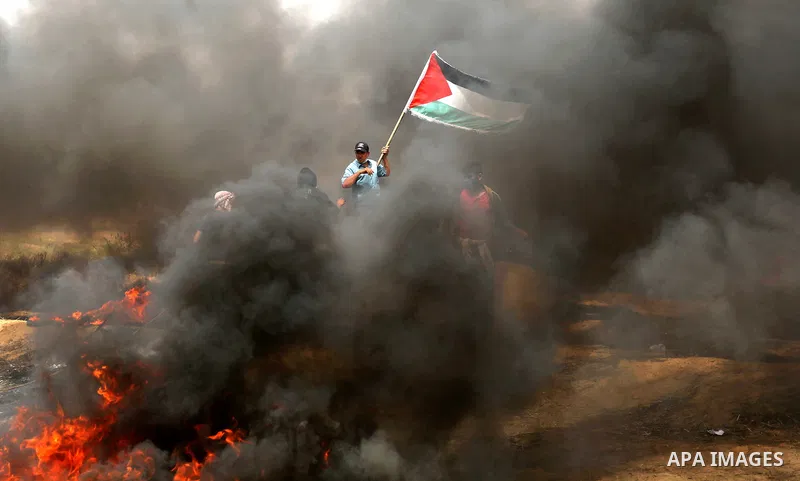 Palestinian protesters burn tires during clashes with Israeli security forces at tents protest at the Israel-Gaza border where Palestinians demand the right to return to their homeland, in Khan Younis in the southern Gaz...