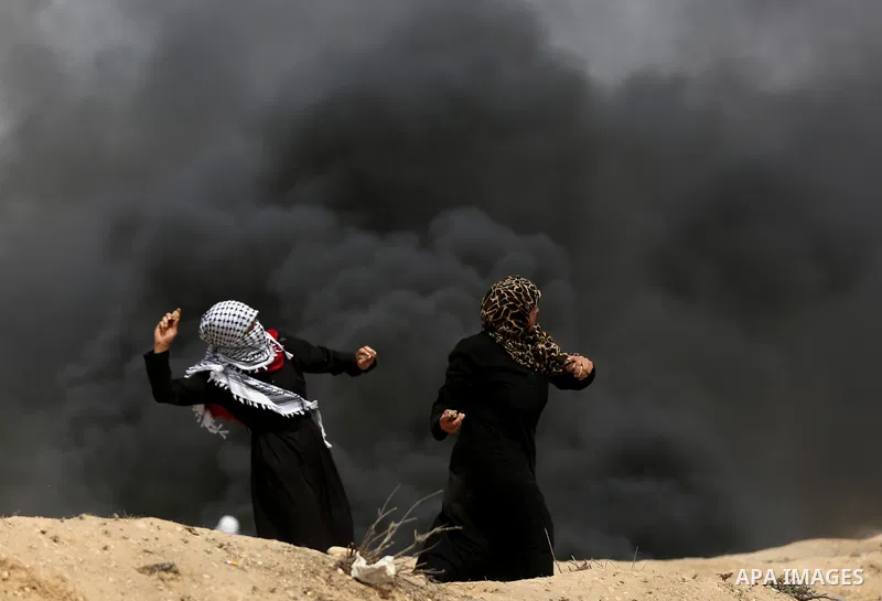 Palestinian women take part during clashes with Israeli security forces at tents protest at the Israel-Gaza border where Palestinians demand the right to return to their homeland, in east of Gaza city on April 20, 2018....