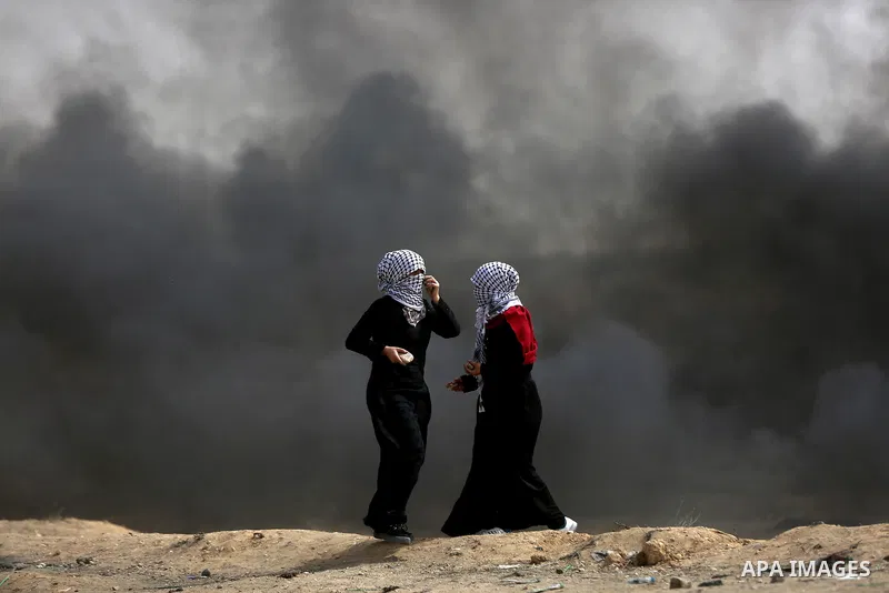 Palestinian women take part during clashes with Israeli security forces at tents protest at the Israel-Gaza border where Palestinians demand the right to return to their homeland, in east of Gaza city on April 20, 2018....