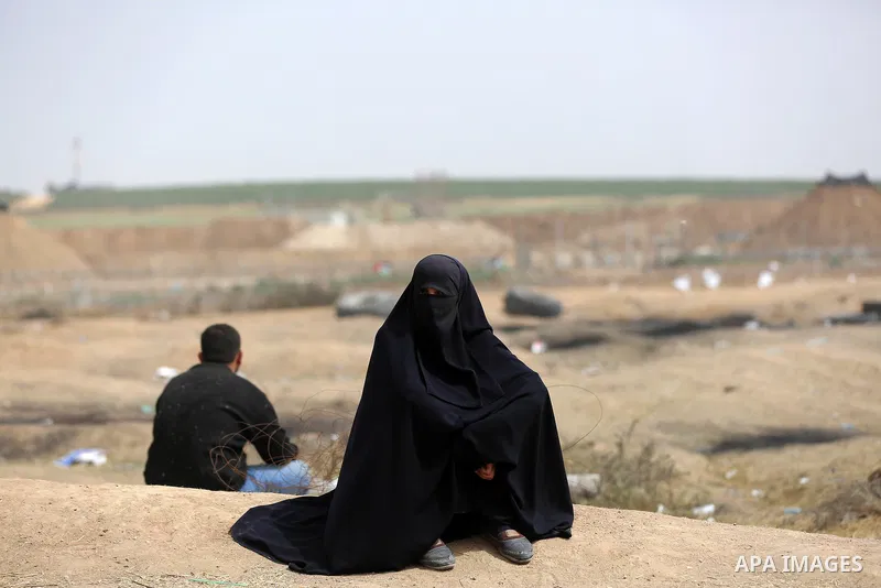 A Palestinian woman wearing veil takes part during clashes with Israeli security forces at tents protest at the Israel-Gaza border where Palestinians demand the right to return to their homeland, in east of Gaza city on...