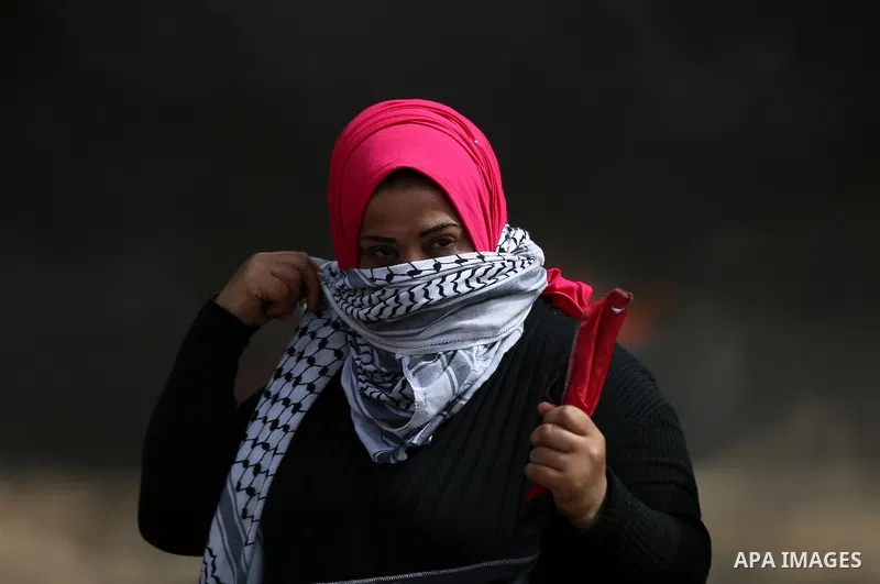 Palestinian women take part during clashes with Israeli security forces at tents protest at the Israel-Gaza border where Palestinians demand the right to return to their homeland, in east of Gaza city on April 20, 2018....