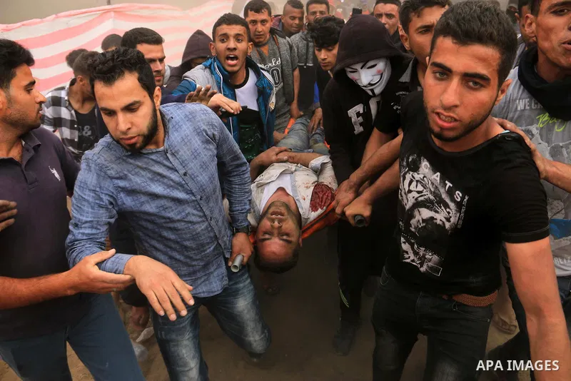 A wounded Palestinian protester is evacuated during clashes with Israeli security forces at tents protest at the Israel-Gaza border where Palestinians demand the right to return to their homeland, in Bureij in the cetner...